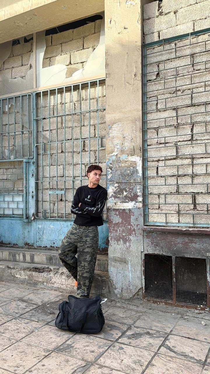 Model in Fxkeel streetwear beside an old stone building